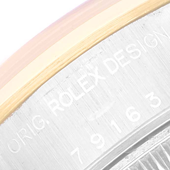 The image shows a close-up of the side engraving on a Rolex Datejust 79163 Women's Steel and Gold (two tone) Beige Dial 79163 Women's Steel and Gold (two tone) Beige Dial's case back.