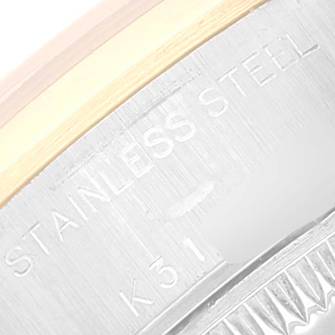 This close-up image shows part of the bezel and case back of a Rolex Datejust 79163 Women's Steel and Gold (two tone) Beige Dial 79163 Women's Steel and Gold (two tone) Beige Dial watch, highlighting its stainless steel construction.