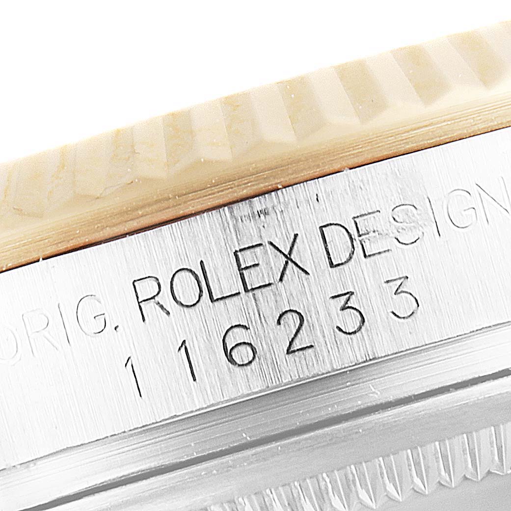 The image shows a close-up of the case side of a Rolex Datejust 116233 Men's Steel and Gold (two tone) Grey Dial 116233 Men's Steel and Gold (two tone) Grey Dial, highlighting its model number and part of the bezel.