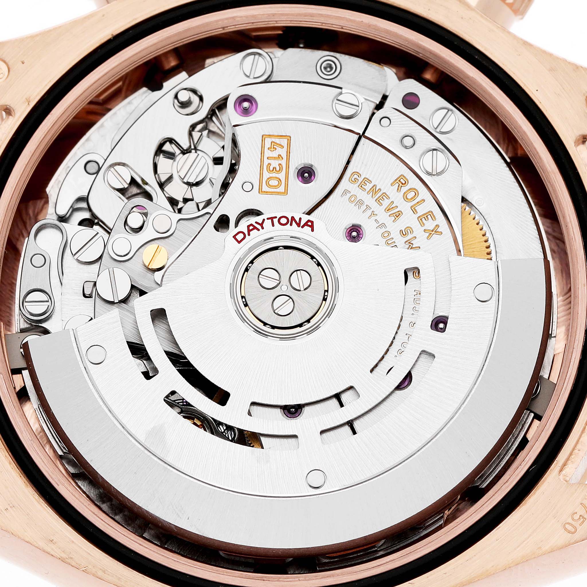 The image shows the Rolex Daytona 116505 Men's Rose Gold Pink Dial watch movement viewed from the back, highlighting gears, the rotor, and intricate mechanics.