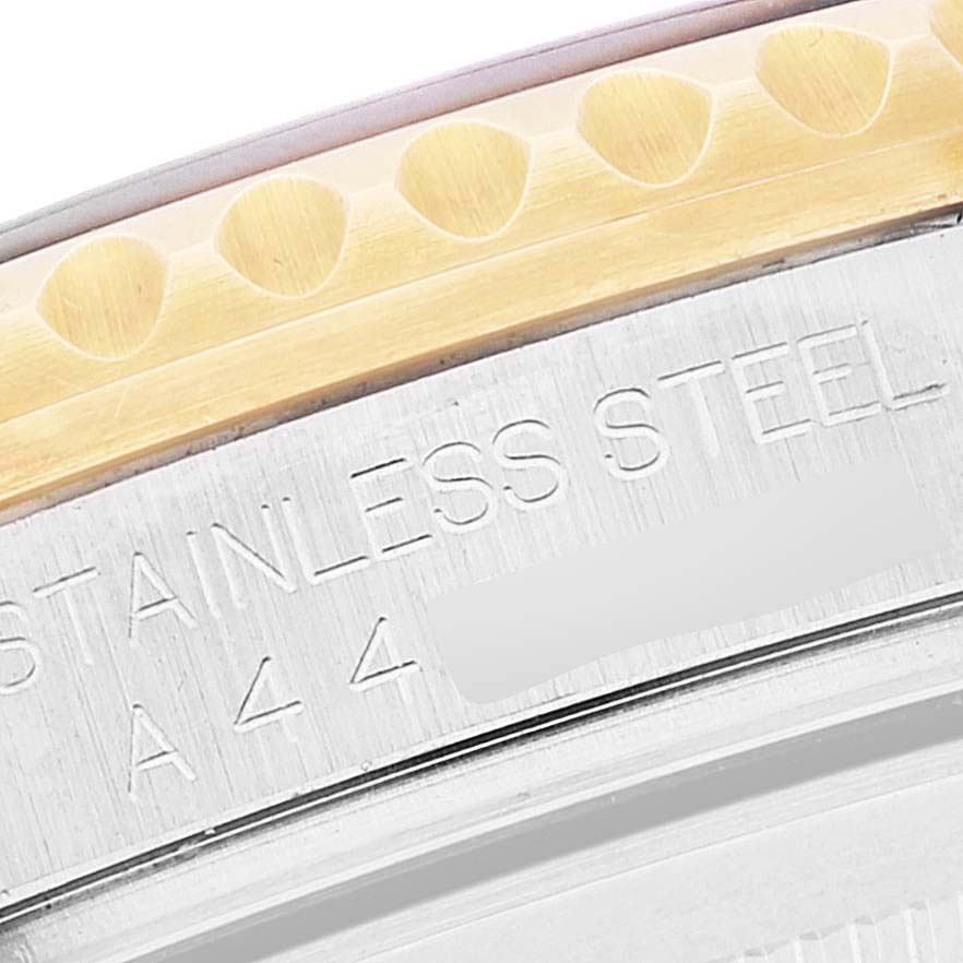 The image shows a close-up angle of the side of a Rolex Submariner 16713 Men's Steel and Gold (two tone) Champagne Dial 16713 Men's Steel and Gold (two tone) Champagne Dial watch, highlighting the stainless steel construction and part of the bezel.