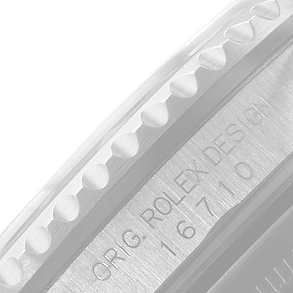 The image shows a close-up of the engraved side of the case and bezel of a Rolex GMT-Master 16710 Men
s Stainless Steel Black Dial 16710 Men
s Stainless Steel Black Dial model.