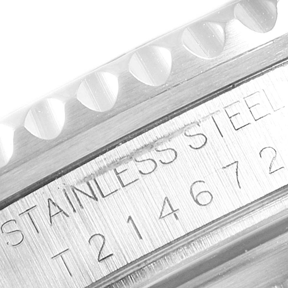 This close-up image of a Rolex GMT-Master 16710 Men's Stainless Steel Black Dial 16710 Men's Stainless Steel Black Dial watch shows the engraved text "STAINLESS STEEL" and part of the bezel edge.