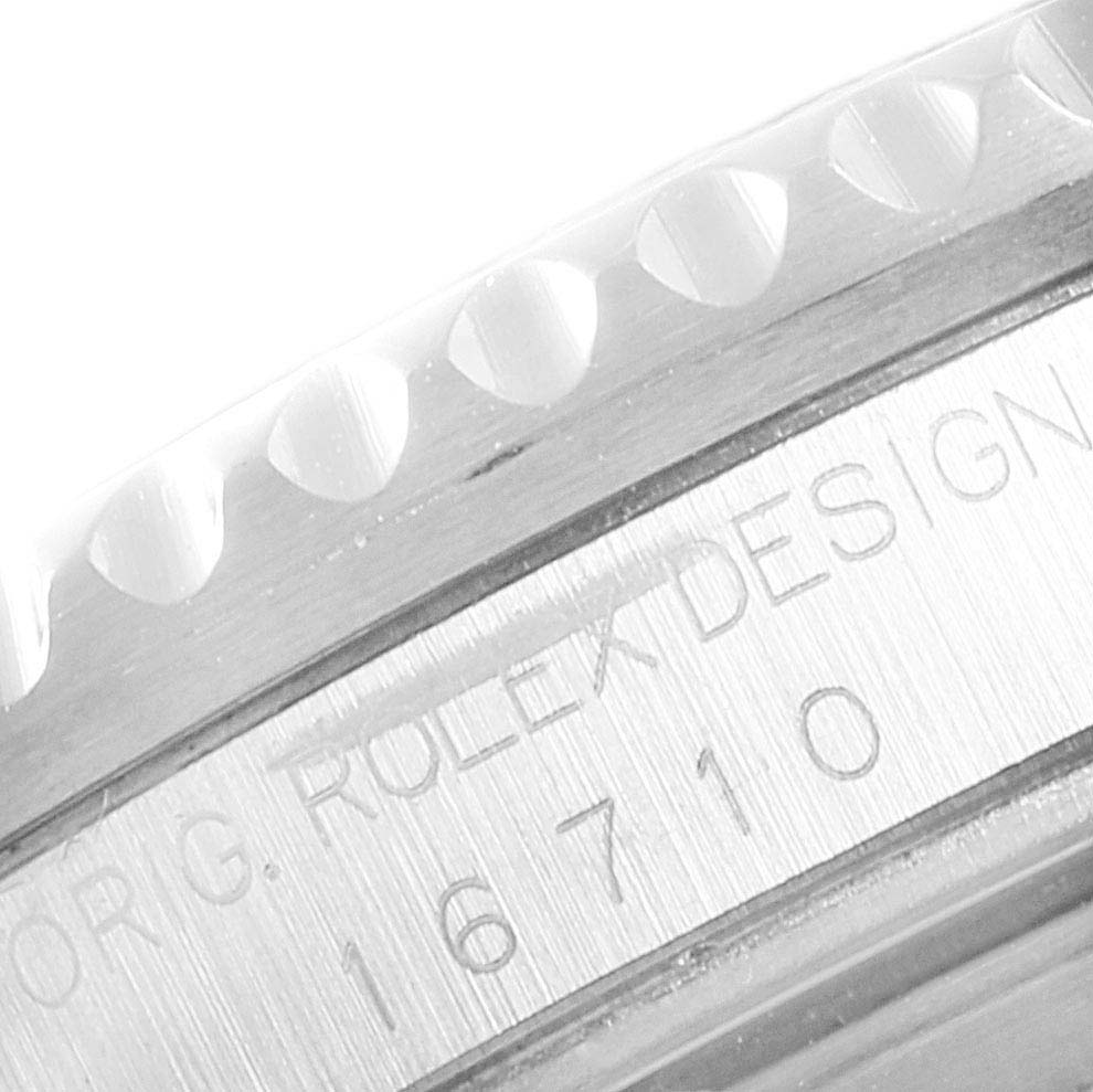 This close-up shot of a Rolex GMT-Master 16710 Men's Stainless Steel Black Dial 16710 Men's Stainless Steel Black Dial shows the edge of the bezel and the engraved model number 16710 on the case.