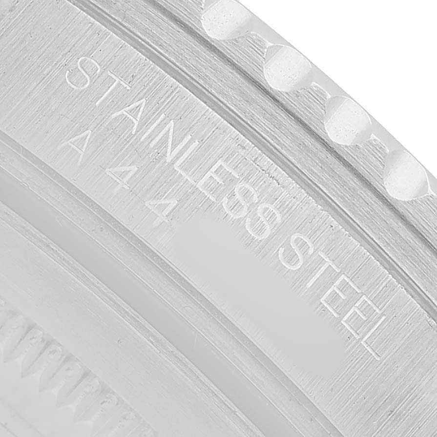 The image shows a close-up of the stainless steel bezel engraving on a Rolex GMT-Master 16700 Men's Stainless Steel Black Dial watch.