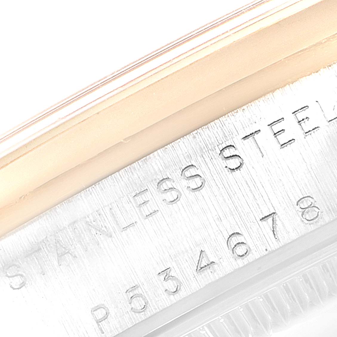 This is a close-up of the serial number and material engraving on the case side of a Mid-Size Rolex watch.