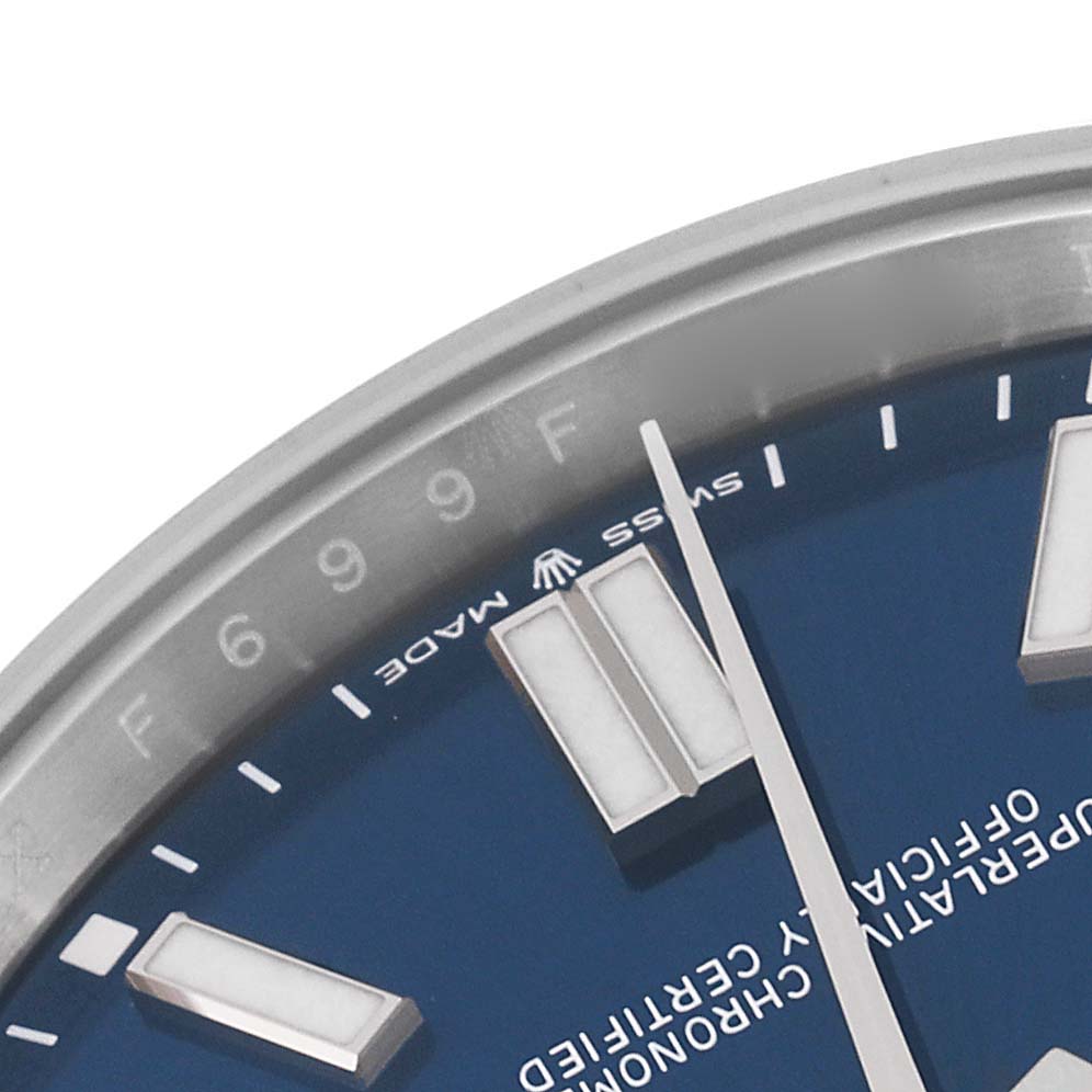 This image shows a close-up of the dial and bezel of the Rolex Oyster Perpetual 124300 Men
s Stainless Steel Blue Dial 124300 Men
s Stainless Steel Blue Dial watch, highlighting the markers and "Swiss Made" text.