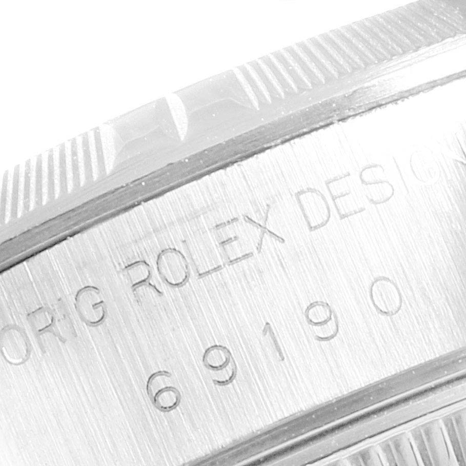 The image shows a close-up of the side of the case with the serial number engraving on a Date model Rolex watch.