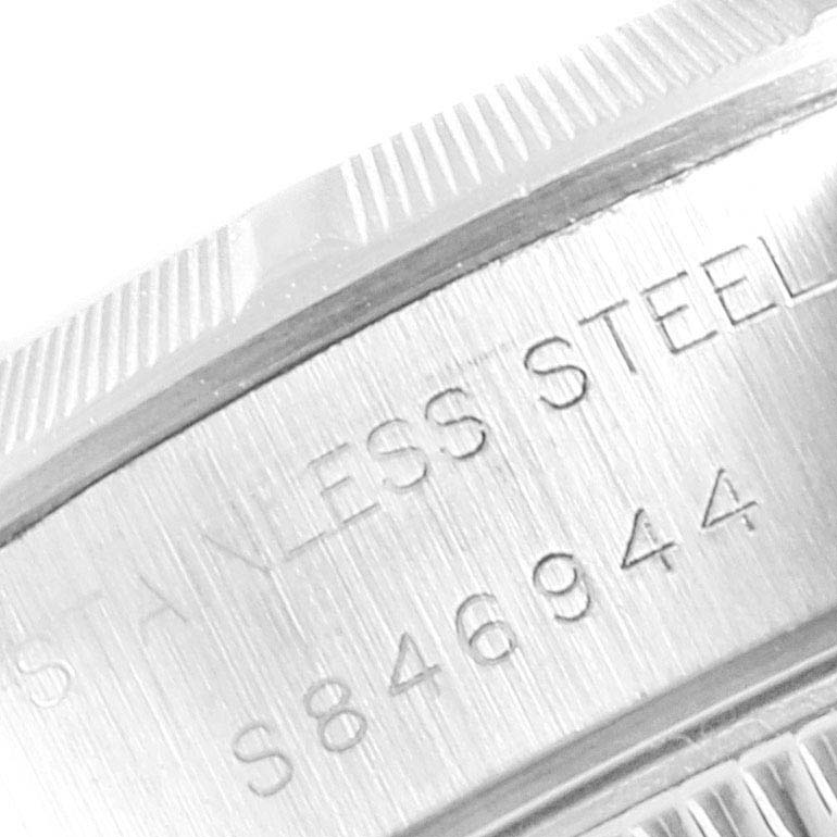 This image shows a close-up angle of the serial number and the words "STAINLESS STEEL" engraved on the side of a Rolex Date 69190 Women's Stainless Steel Champagne Dial 69190 Women's Stainless Steel Champagne Dial model watch.