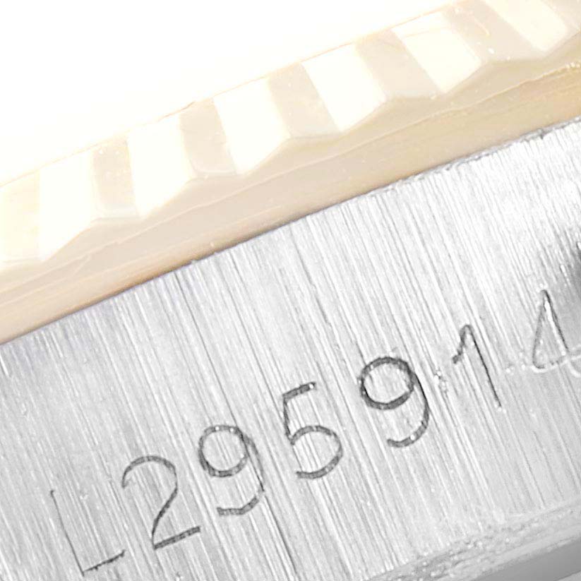 The image shows a close-up of the serial number engraved on the case side of a Rolex Oyster Perpetual 67193 Women
s Steel and Gold (two tone) White Dial 67193 Women
s Steel and Gold (two tone) White Dial watch.