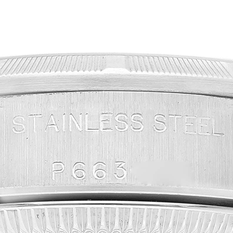 This image shows a close-up of the stainless steel case back of a Rolex Oyster Perpetual 76030 Women
s Stainless Steel White Dial 76030 Women
s Stainless Steel White Dial watch, detailing the material and partial serial number.