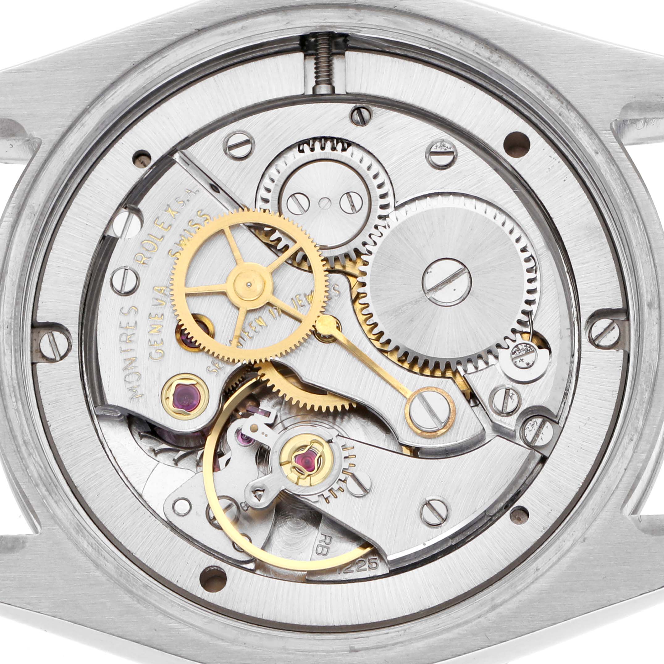 The image shows the movement mechanism of a Rolex Date 6694 Men's Stainless Steel Silver Dial 6694 Men's Stainless Steel Silver Dial model, highlighting gears and internal components.
