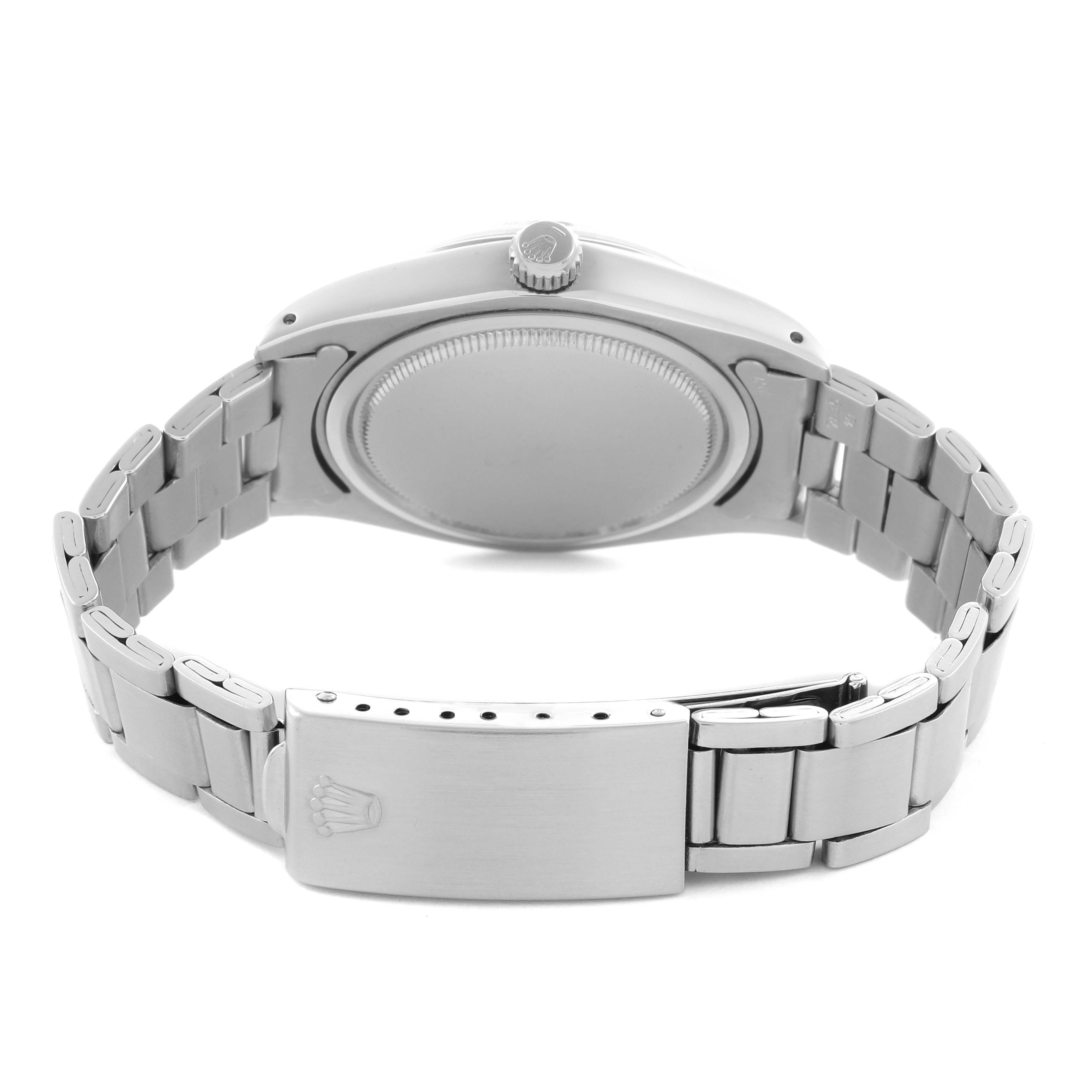 The Rolex Date 6694 Men's Stainless Steel Silver Dial 6694 Men's Stainless Steel Silver Dial watch is shown from the back, highlighting the case back, bracelet, clasp, and crown.