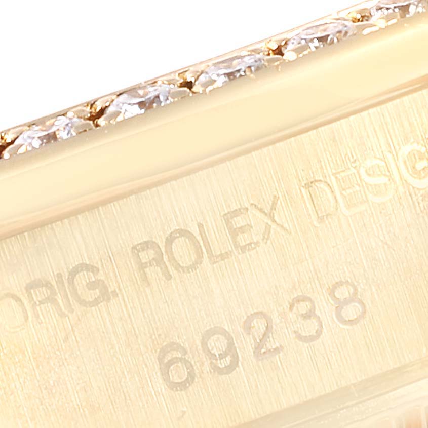 The image shows a close-up of the engraved design number on the side case of a Rolex President 69238 Women
s Yellow Gold Mother of Pearl Dial 69238 Women
s Yellow Gold Mother of Pearl Dial model watch.