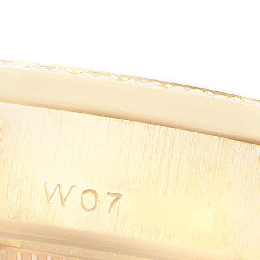 This close-up image shows the engraved serial number on the side of the case of a Rolex President 69238 Women
s Yellow Gold Mother of Pearl Dial 69238 Women
s Yellow Gold Mother of Pearl Dial model watch.