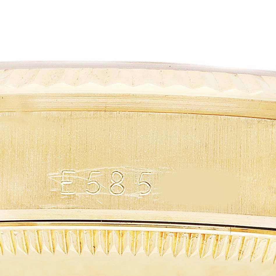 The image shows a close-up of the side of a Rolex Datejust 68278 Women's Yellow Gold White Dial case, highlighting the bezel and engravings.
