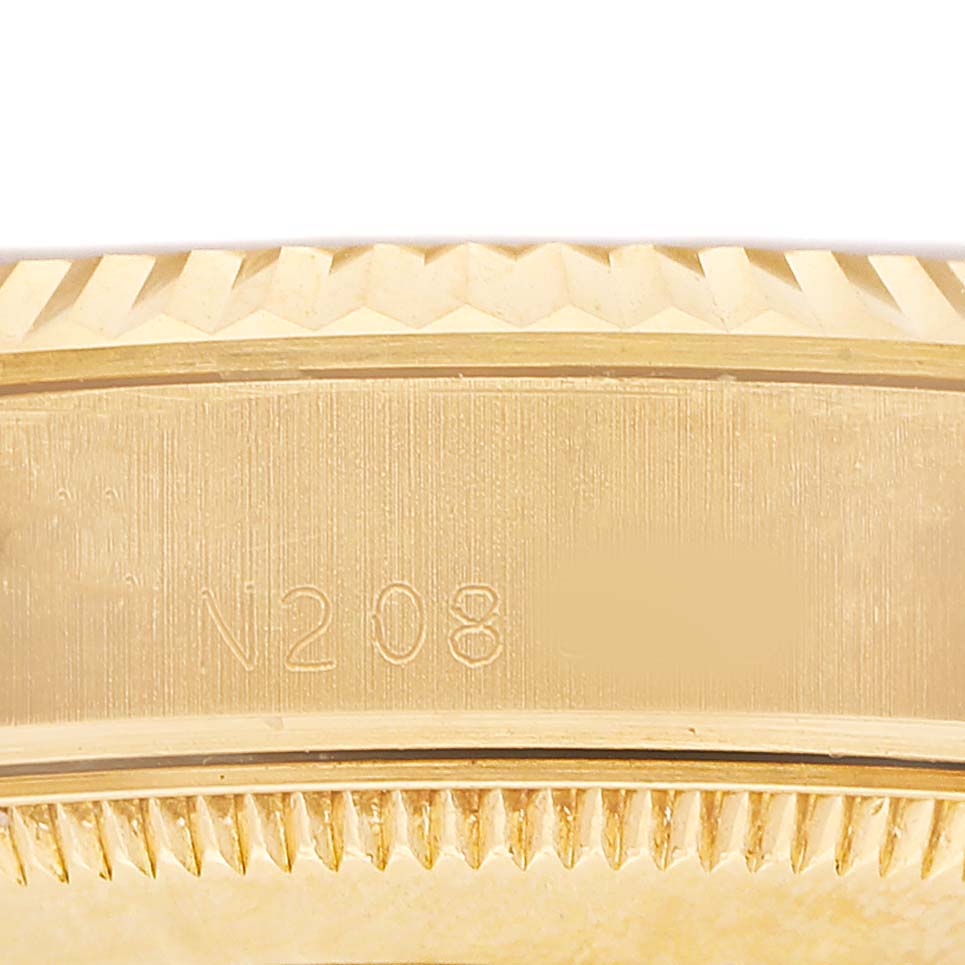 The image shows a close-up side view of the case and bezel of a Rolex Datejust 68278 Women's Yellow Gold White Dial, highlighting the fluted bezel details and engraved code.