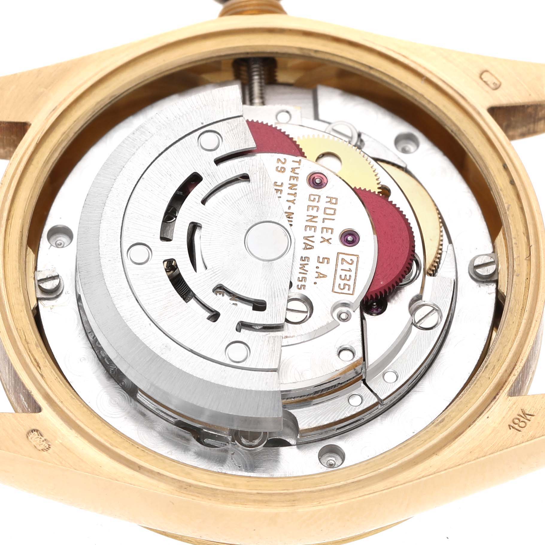 The image shows the movement of a Rolex Datejust 68278 Women's Yellow Gold White Dial watch from the back, highlighting the rotor and gears.