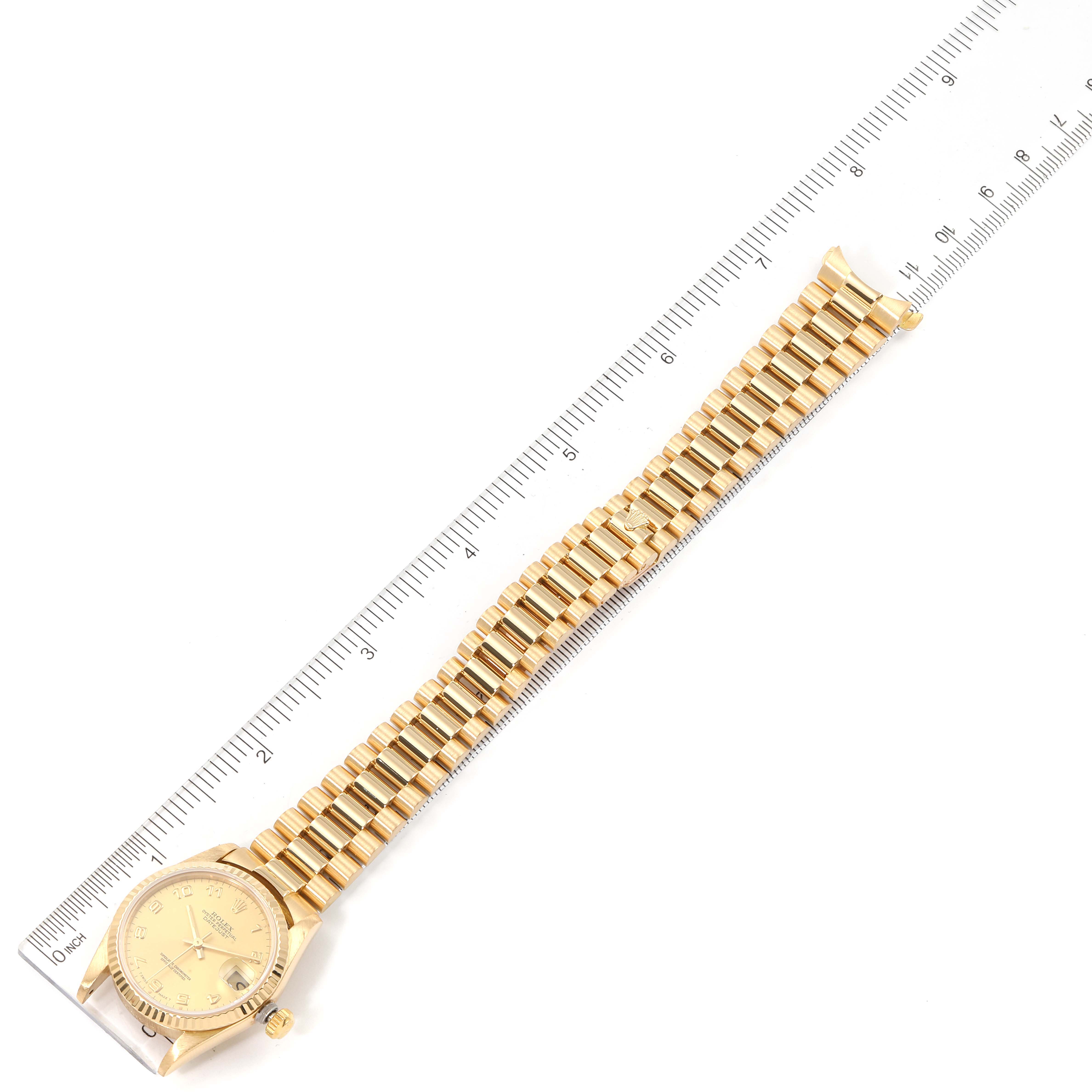The image shows a top-down view of the Rolex President 68278 Women
s Yellow Gold Champagne Dial 68278 Women
s Yellow Gold Champagne Dial model watch, displaying the entire band and face next to a ruler for scale.