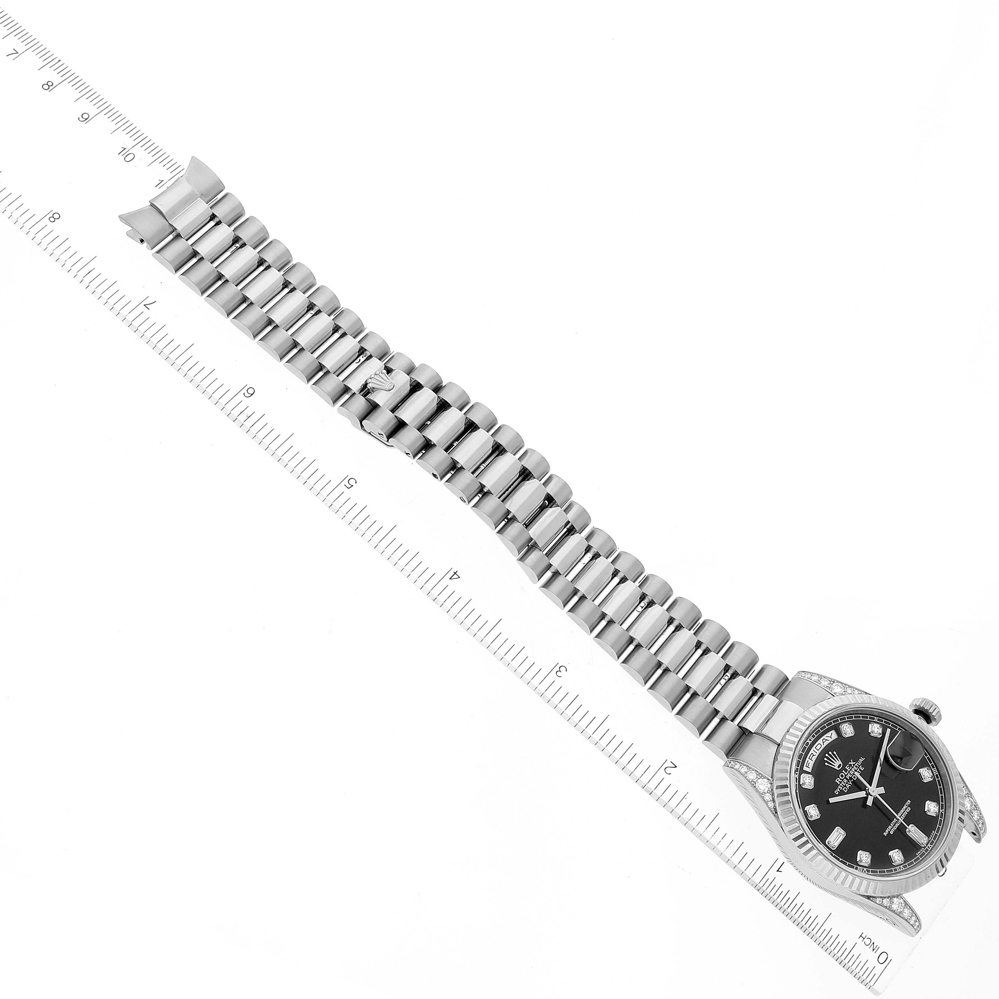 The image shows an overhead view of a Rolex President 118339 Men's White Gold Black Dial 118339 Men's White Gold Black Dial model watch with the band extended and a ruler beside it for scale.