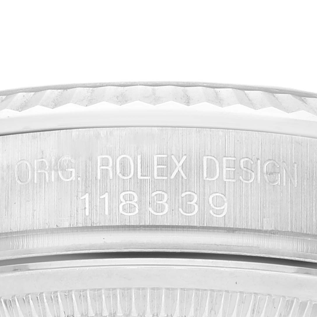 This close-up image shows the serial number and part of the bezel of a Rolex President 118339 Men's White Gold Black Dial 118339 Men's White Gold Black Dial model watch.
