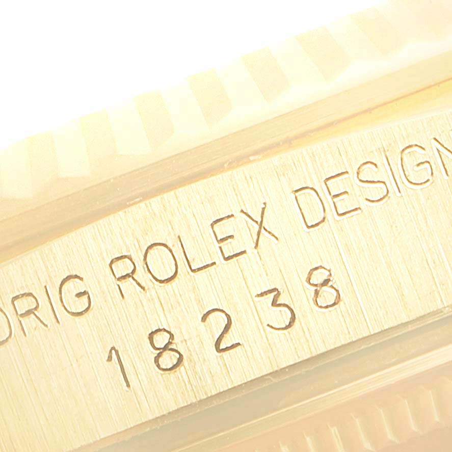 This image shows a close-up view of the engraved model number and fluted bezel of a Rolex President 18238 Men
s Yellow Gold White Dial 18238 Men
s Yellow Gold White Dial watch.