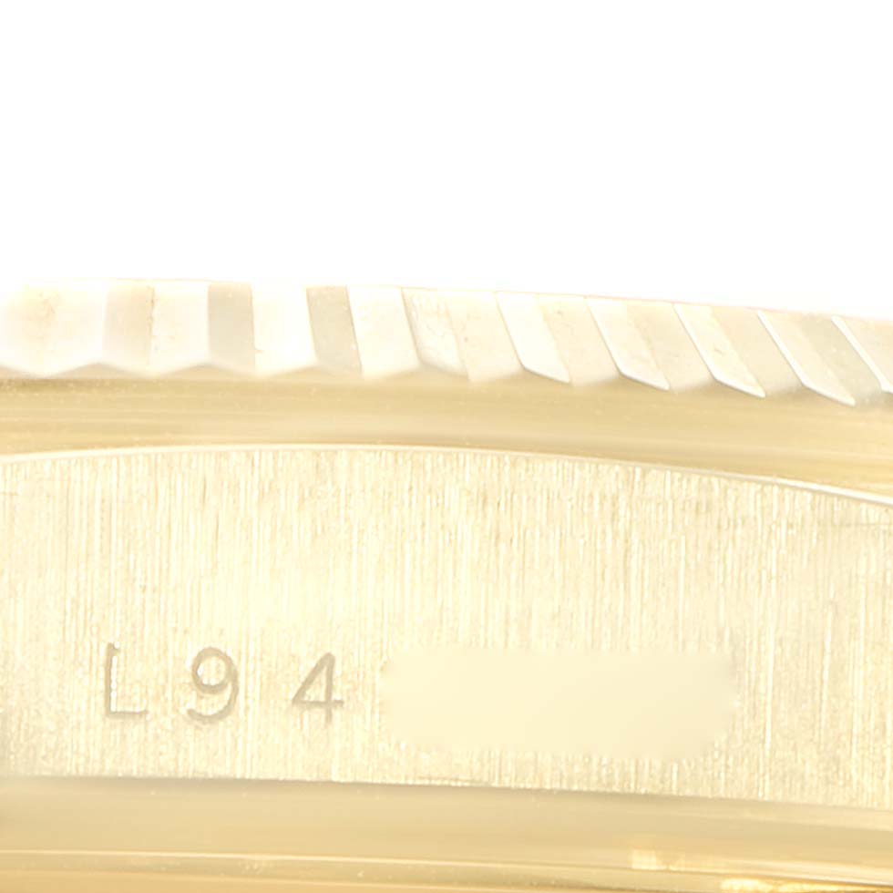 The image shows a close-up of the edge of the bezel and part of the case with engraved serial numbers on the Rolex President 18238 Men
s Yellow Gold White Dial 18238 Men
s Yellow Gold White Dial model watch.
