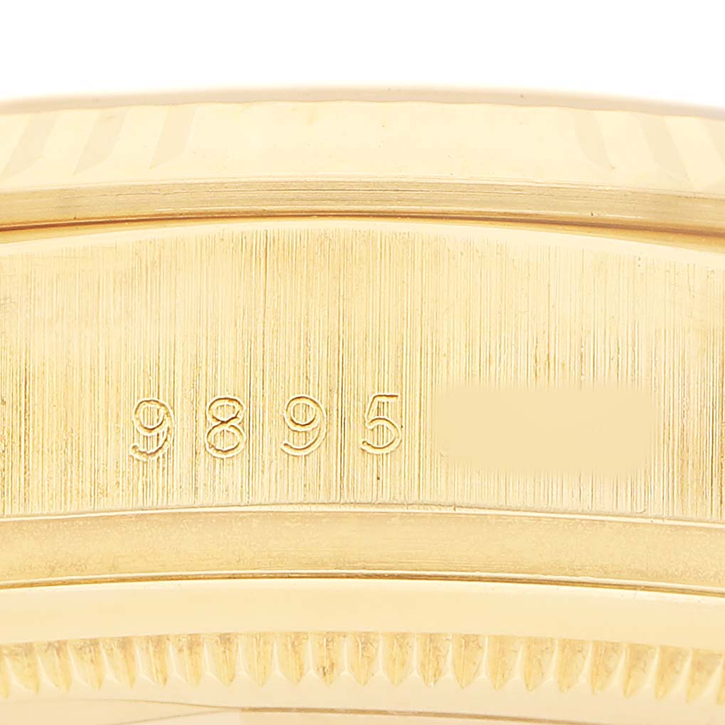 The image shows a close-up of the engraved serial number on the side of a Rolex President 18038 Men's Yellow Gold Champagne Dial watch case.