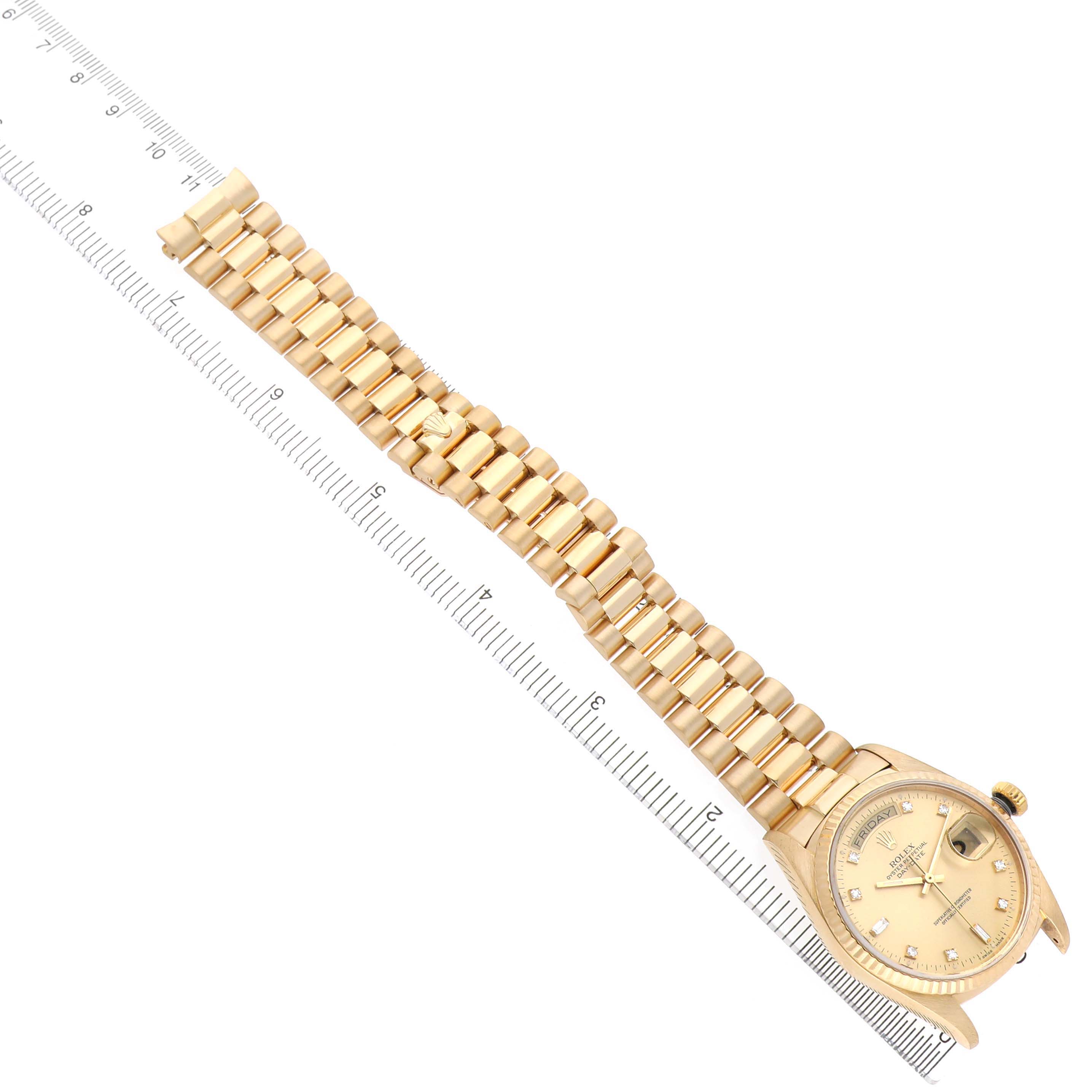 The Rolex President 18038 Men's Yellow Gold Champagne Dial model watch is shown from a top-down angle, displaying its full bracelet, dial, and crown.
