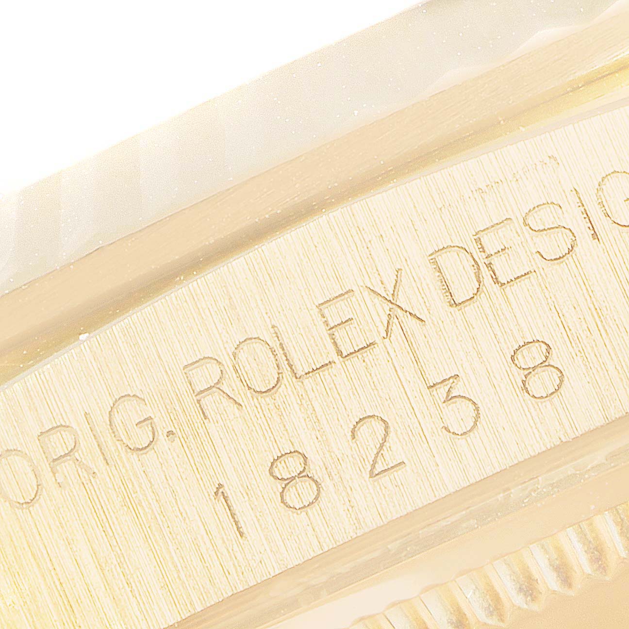 The image shows a close-up of the engraved model number and serial of the Rolex President 18238 Men
s Yellow Gold Champagne Dial 18238 Men
s Yellow Gold Champagne Dial watch.