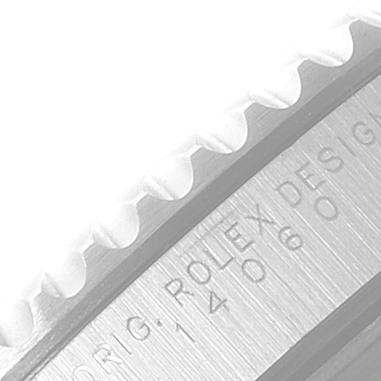 The image shows a close-up angle of the engraved inner bezel and part of the outer edge of a Rolex Submariner 14060 Men's Stainless Steel Black Dial 14060 Men's Stainless Steel Black Dial watch.