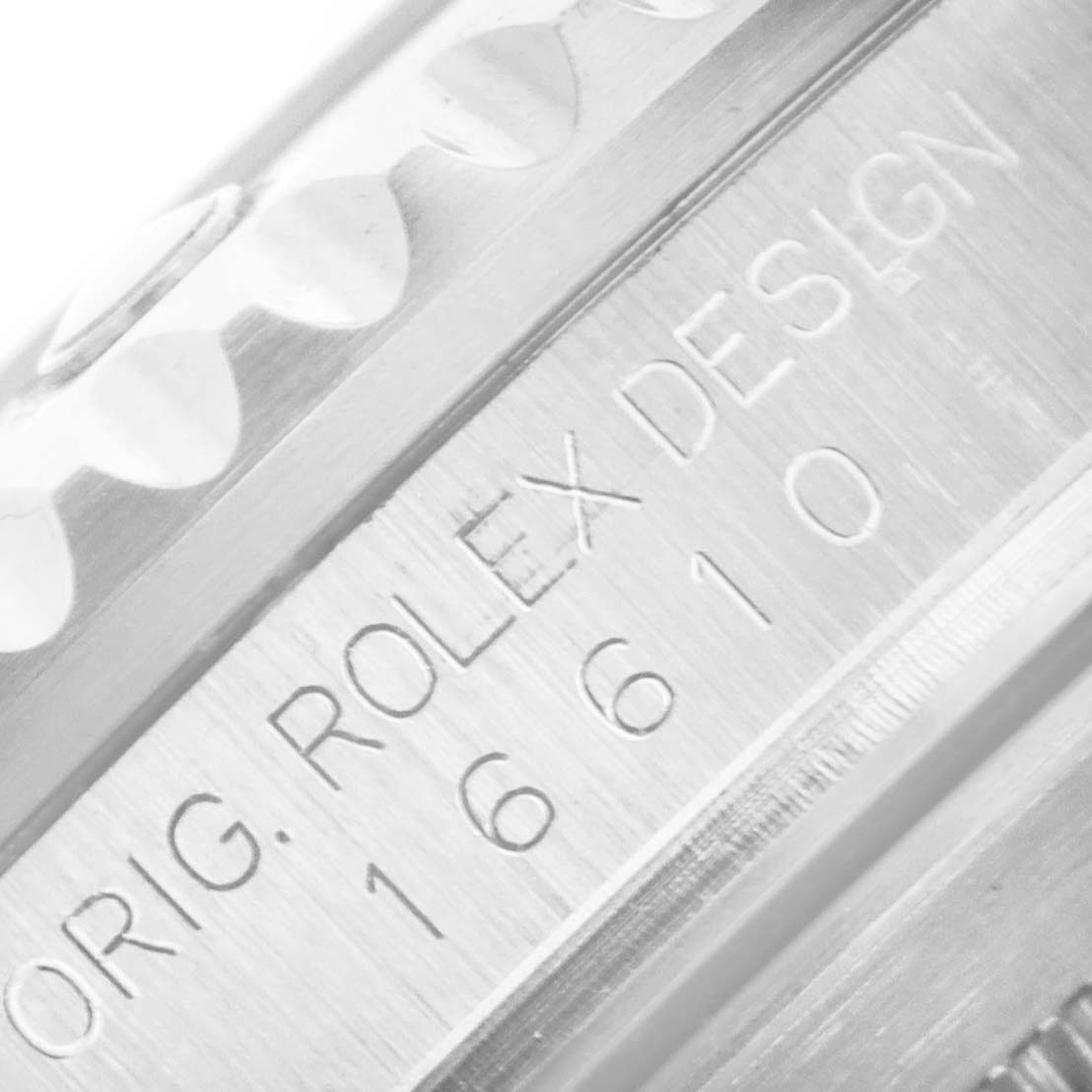 Close-up of the side of the bezel and engraved text on a Rolex Submariner 16610 Men
s Stainless Steel Black Dial 16610 Men
s Stainless Steel Black Dial displaying "ORIG. ROLEX DESIGN 16610".