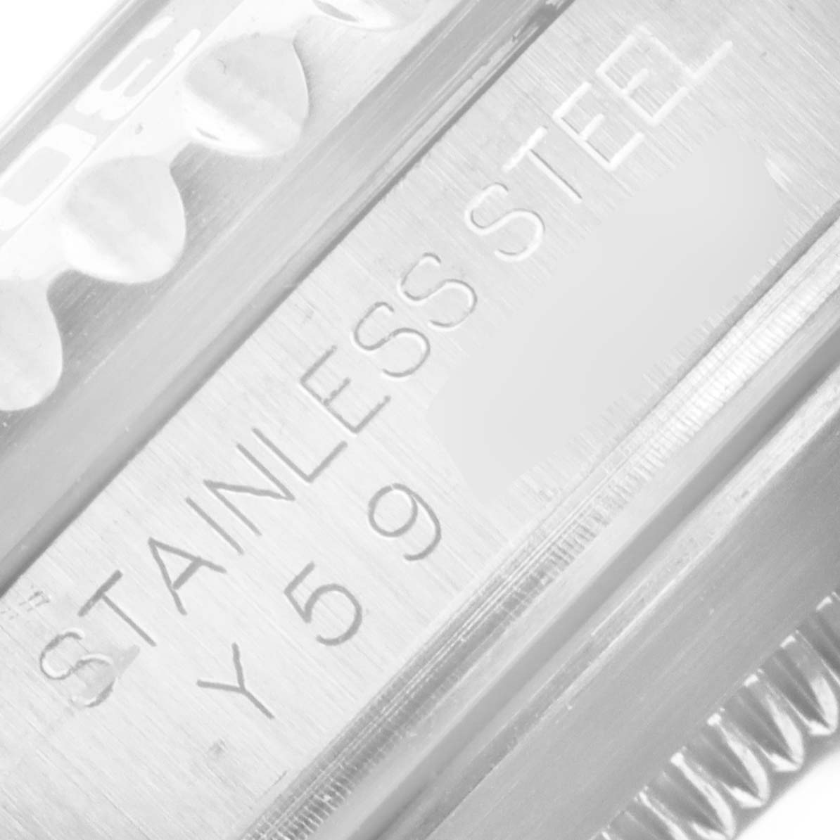 This close-up image shows the stainless steel bezel and serial number engraving of a Rolex Submariner 16610 Men
s Stainless Steel Black Dial 16610 Men
s Stainless Steel Black Dial watch.