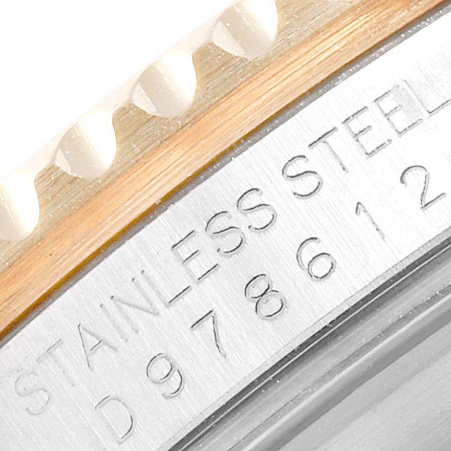 This is a close-up angle showing the engraved text and edge of the bezel on a Rolex Submariner 16613 Men
s Steel and Gold (two tone) Blue Dial 16613 Men
s Steel and Gold (two tone) Blue Dial watch.