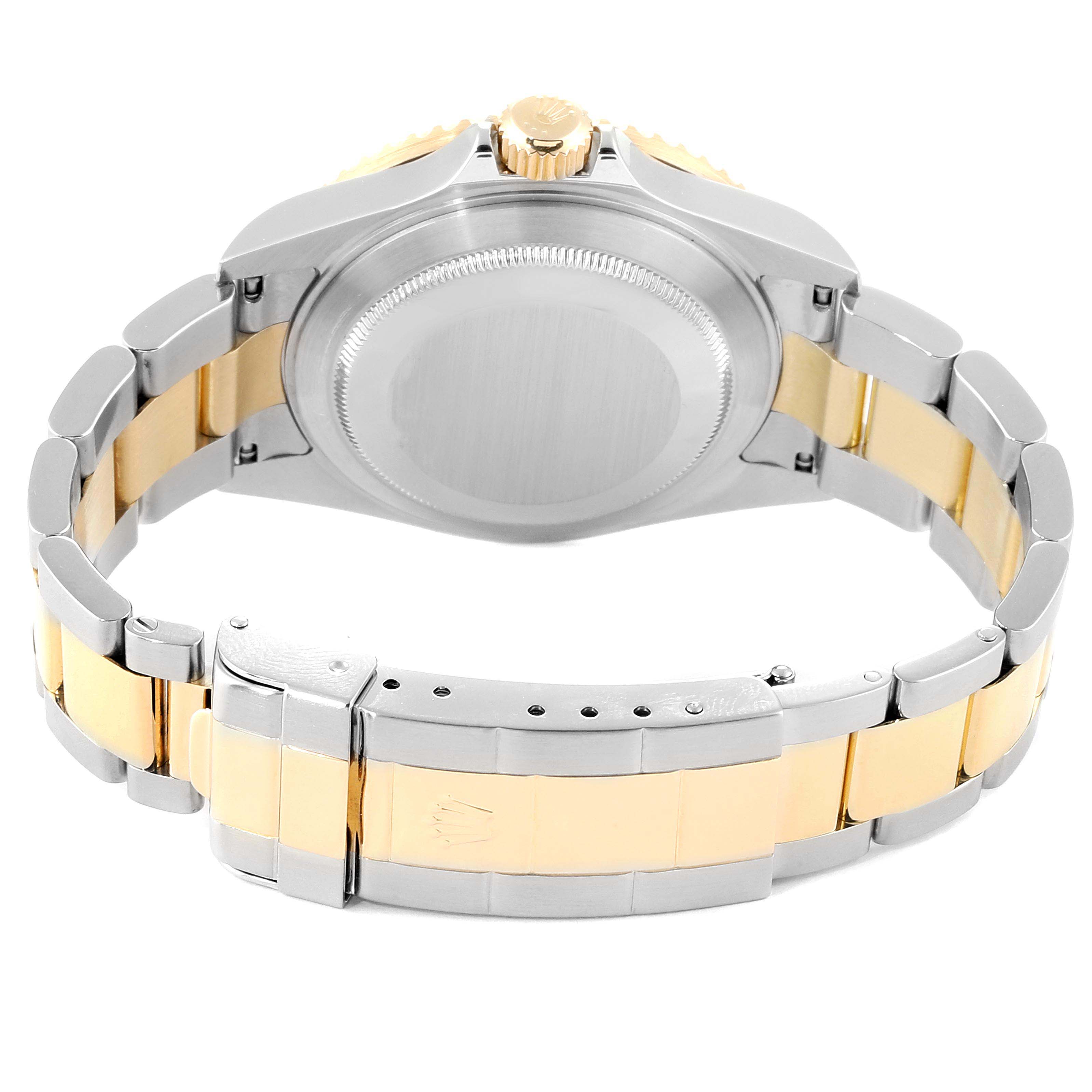 The image shows the back of a Rolex Submariner 16613 Men
s Steel and Gold (two tone) Blue Dial 16613 Men
s Steel and Gold (two tone) Blue Dial watch, focusing on its two-tone metal bracelet and closed clasp.