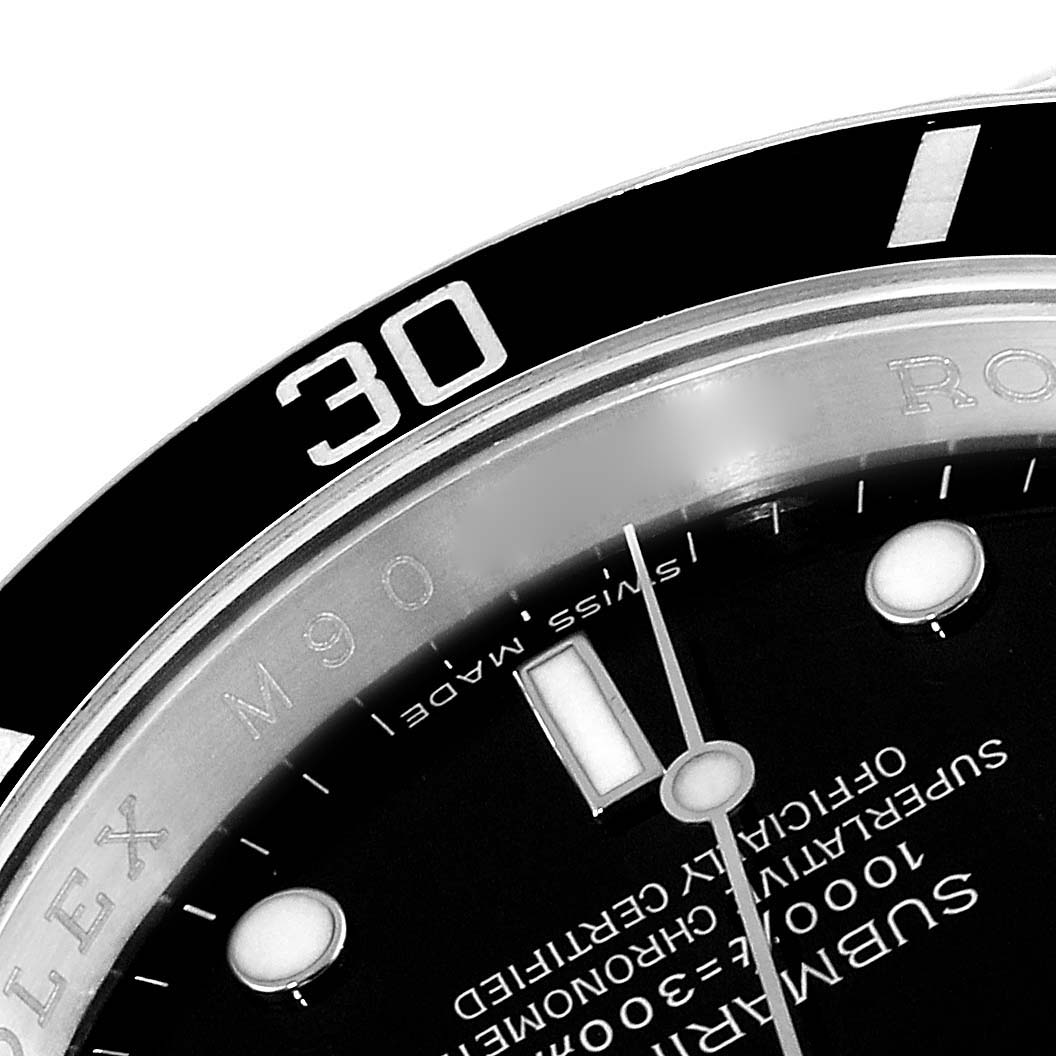 The image shows a close-up of the dial and bezel of the Rolex Submariner 16610 Men
s Stainless Steel Black Dial 16610 Men
s Stainless Steel Black Dial watch, focusing on the minute marker and part of the text on the watch face.