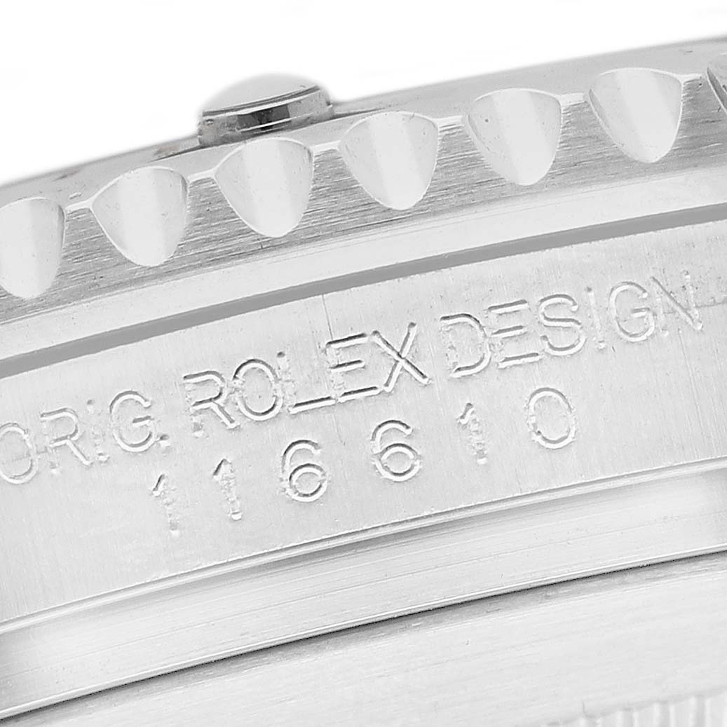 The image shows a close-up of the engraved side of a Rolex Submariner 116610LV Men's Stainless Steel Green Dial case, featuring the model number and design text.