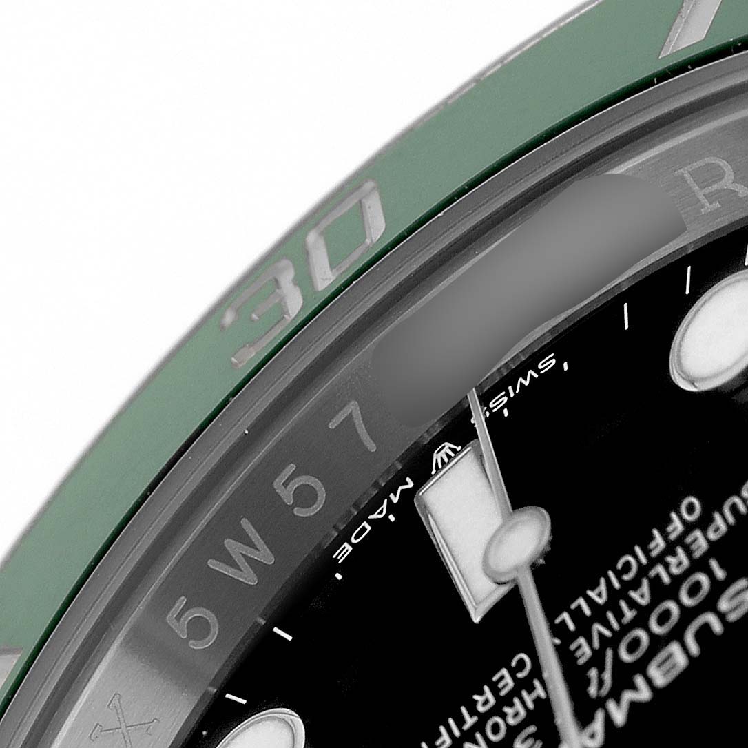 This image shows a close-up of the bezel and part of the dial of a Rolex Submariner 126610LV Men's Stainless Steel Black Dial watch at an angle, highlighting the markings and text.