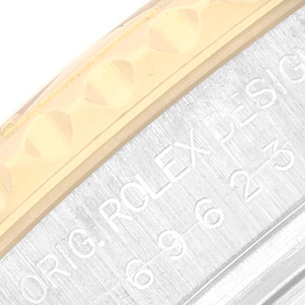 This close-up shows part of the bezel and engraved casing of the Rolex Yacht-Master 69623 Women's Steel and Gold (two tone) White Dial 69623 Women's Steel and Gold (two tone) White Dial watch.