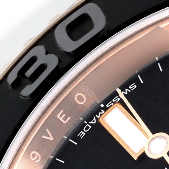 The image shows a close-up of the bezel and part of the dial of a Rolex Yacht-Master 116655 Men's Rose Gold Black Dial 116655 Men's Rose Gold Black Dial watch.