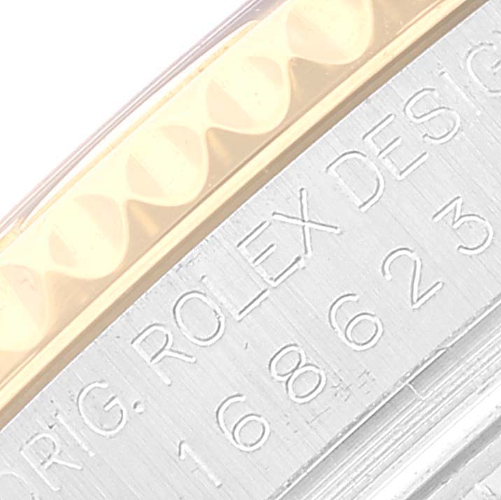 This image shows a close-up of the engraved side of a Rolex Yacht-Master 168623 Men's Steel and Gold (two tone) Blue Dial 168623 Men's Steel and Gold (two tone) Blue Dial watch, displaying part of the brand name and model design.