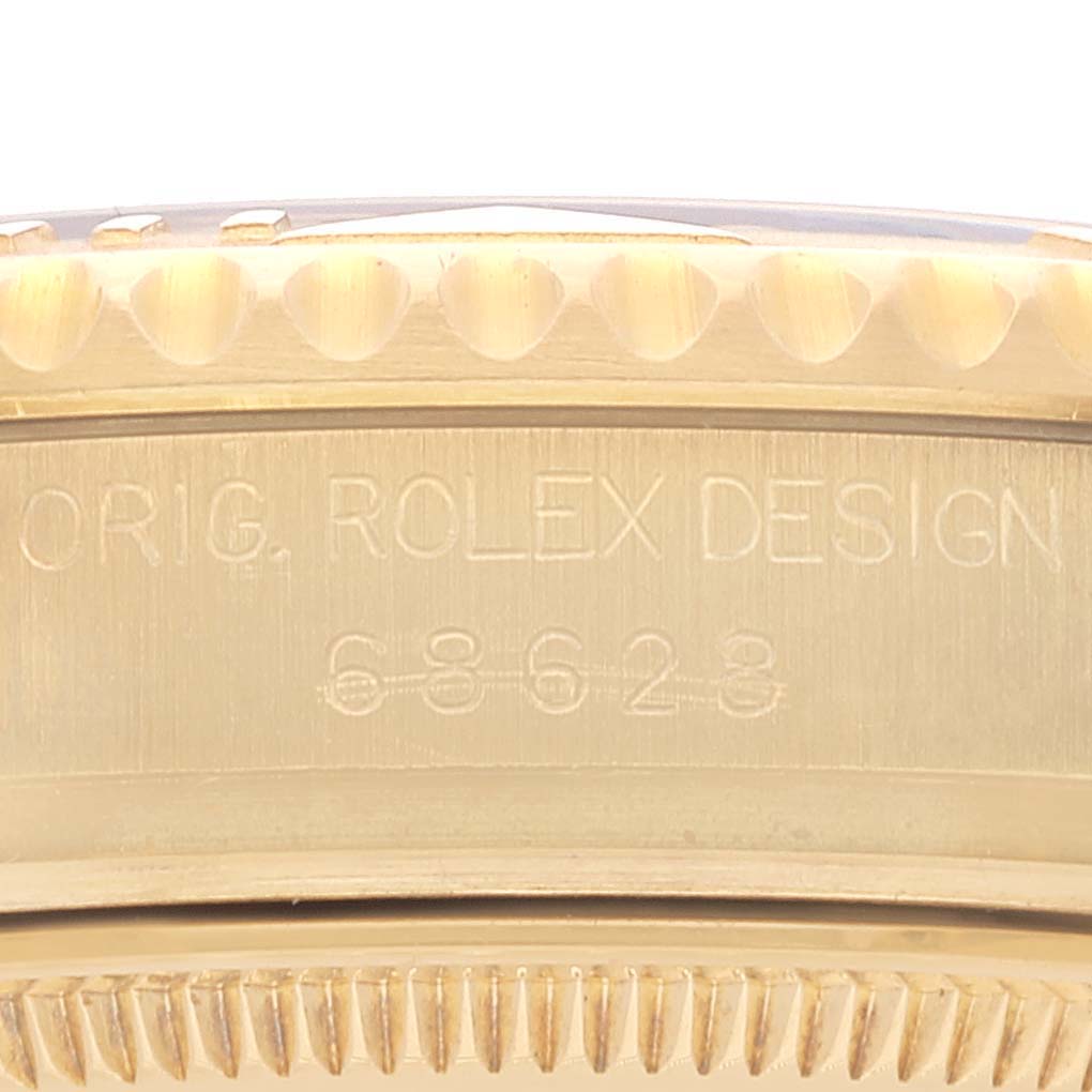 The image shows a close-up of the side of a Rolex Yacht-Master 68628 Men's Yellow Gold White Dial 68628 Men's Yellow Gold White Dial watch, highlighting the bezel edge and engraved model number.