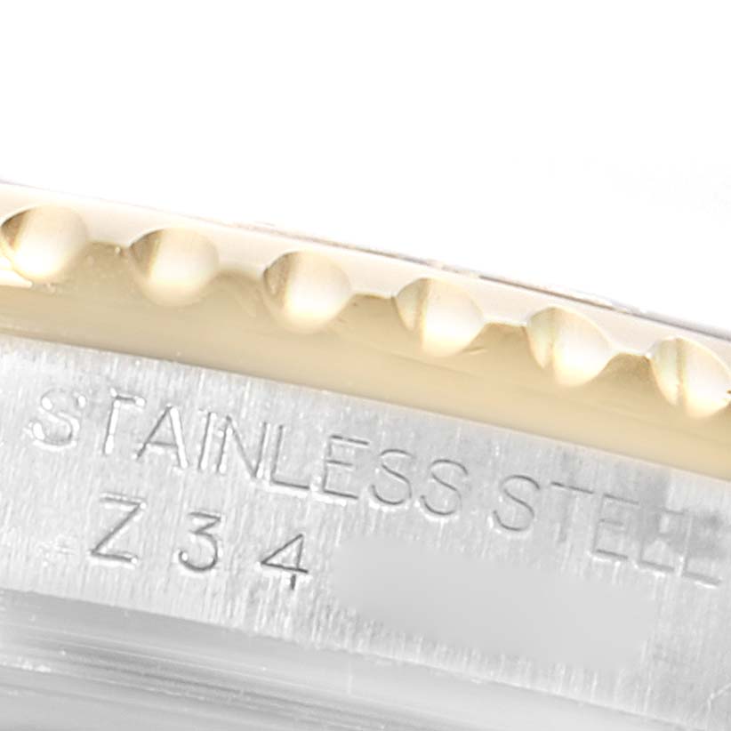 Close-up of the bezel and case side of a Rolex Yacht-Master 16623 Men
s Steel and Gold (two tone) Champagne Dial 16623 Men
s Steel and Gold (two tone) Champagne Dial watch, displaying the "STAINLESS STEEL" engraving.