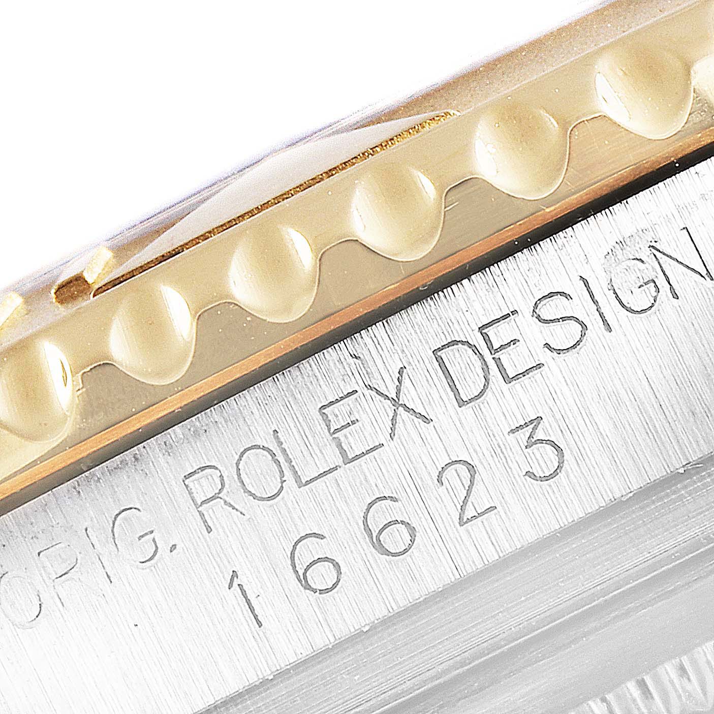 The image shows a close-up of the case side and bezel of a Rolex Yacht-Master 16623 Men
s Steel and Gold (two tone) Champagne Dial 16623 Men
s Steel and Gold (two tone) Champagne Dial model with Rolex Design and 16623 engraved.