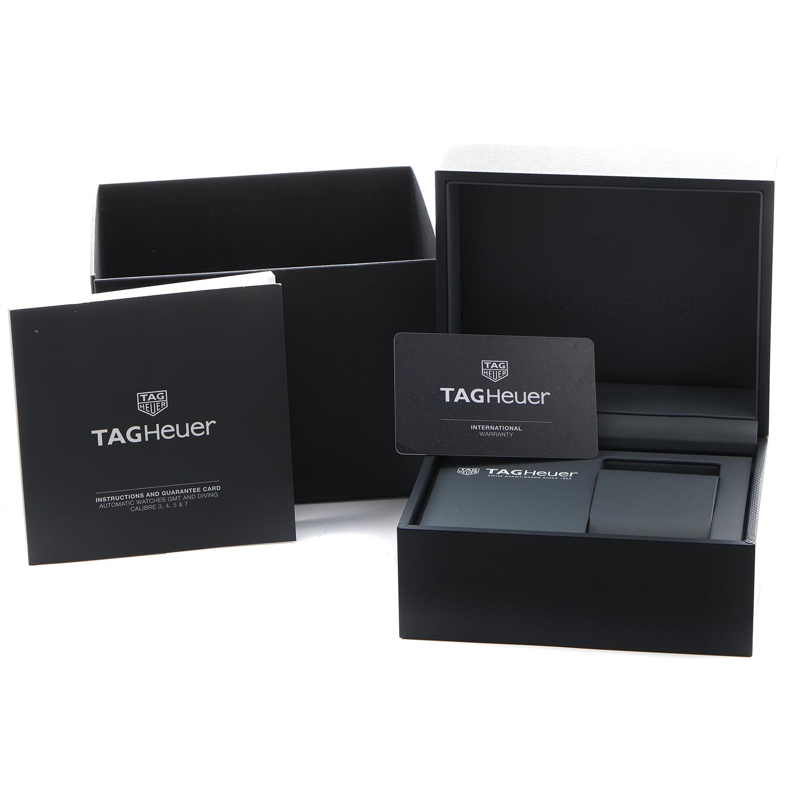 The image shows the box and packaging accessories for a Tag Heuer Aquaracer CAY211B.BA0927 Men's Stainless Steel Blue Dial CAY211B.BA0927 Men's Stainless Steel Blue Dial, including the warranty card and instruction booklet.