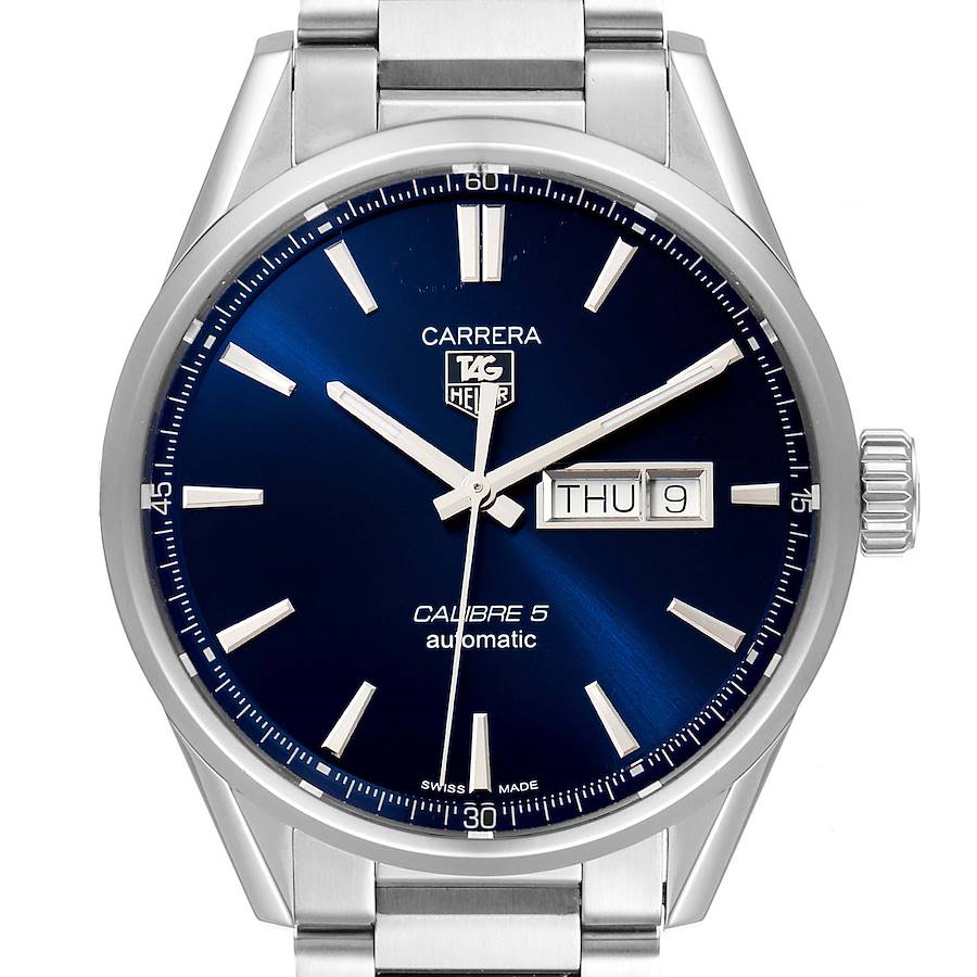 The image shows a front angle of the Tag Heuer Carrera model watch, highlighting its blue dial, day-date display, and stainless steel bracelet.