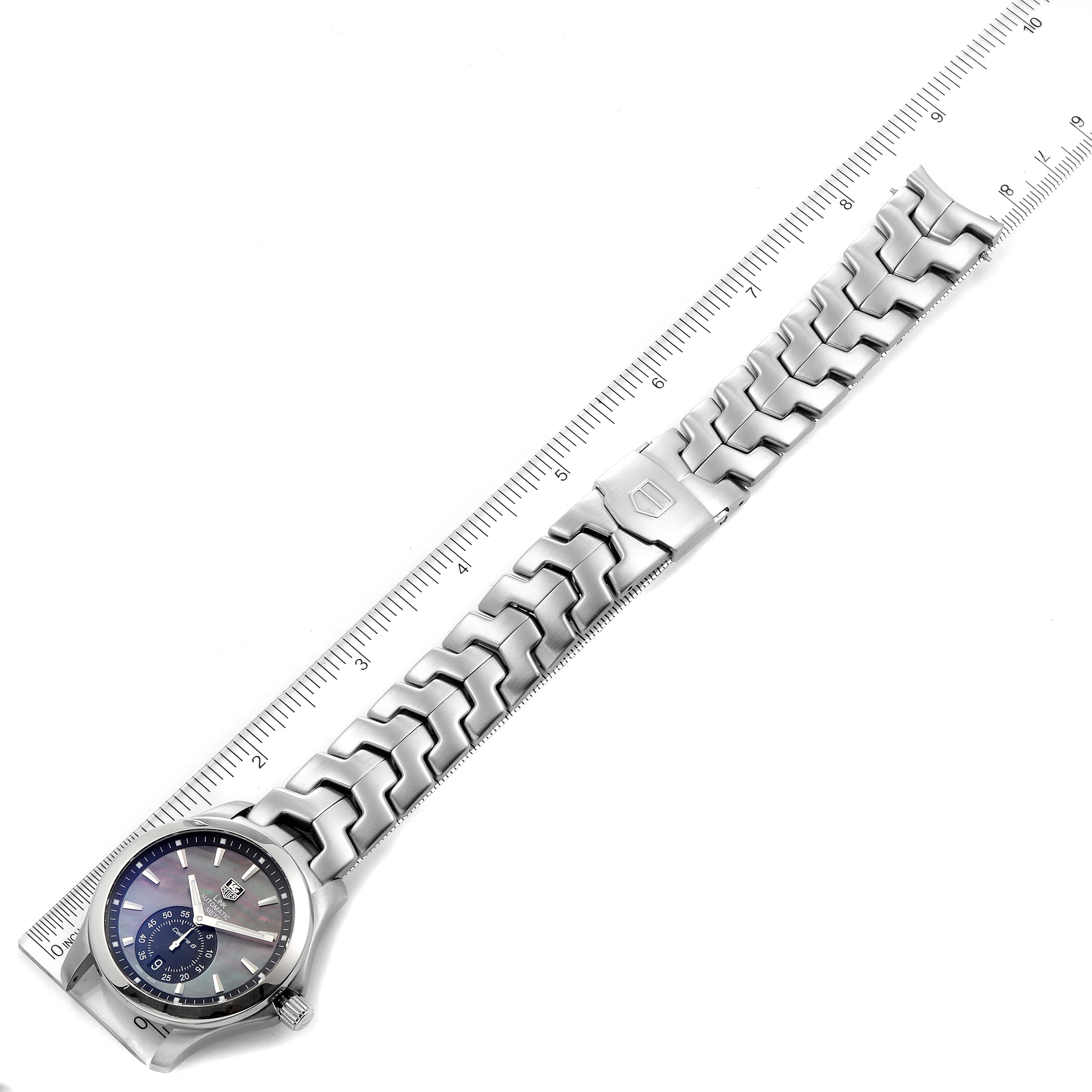 The image shows a Tag Heuer Link WJF211K.BA0570 Men's Stainless Steel Mother of Pearl Dial WJF211K.BA0570 Men's Stainless Steel Mother of Pearl Dial model watch laid flat with its bracelet fully extended, aligned next to a ruler.