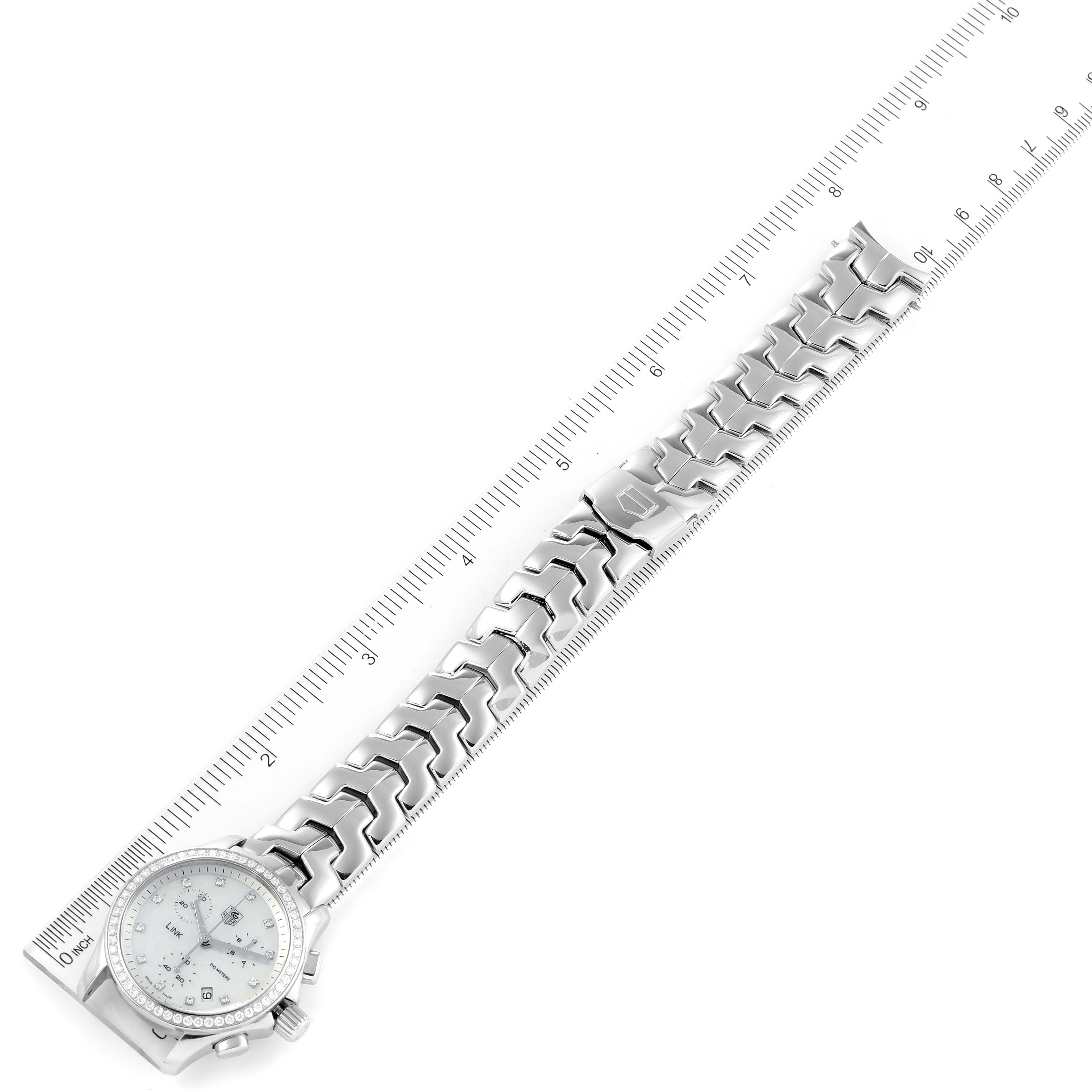 The image shows a Tag Heuer Link CJF1314 Women's Stainless Steel Mother of Pearl Dial CJF1314 Women's Stainless Steel Mother of Pearl Dial model watch laid flat, with its full bracelet and a ruler beside it.