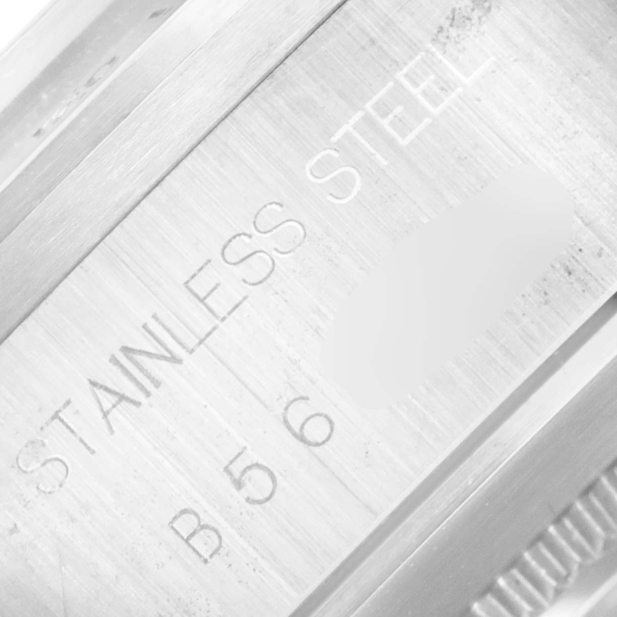 This close-up image shows the side of the Prince model watch by Tudor including part of the stainless steel case and some engravings.