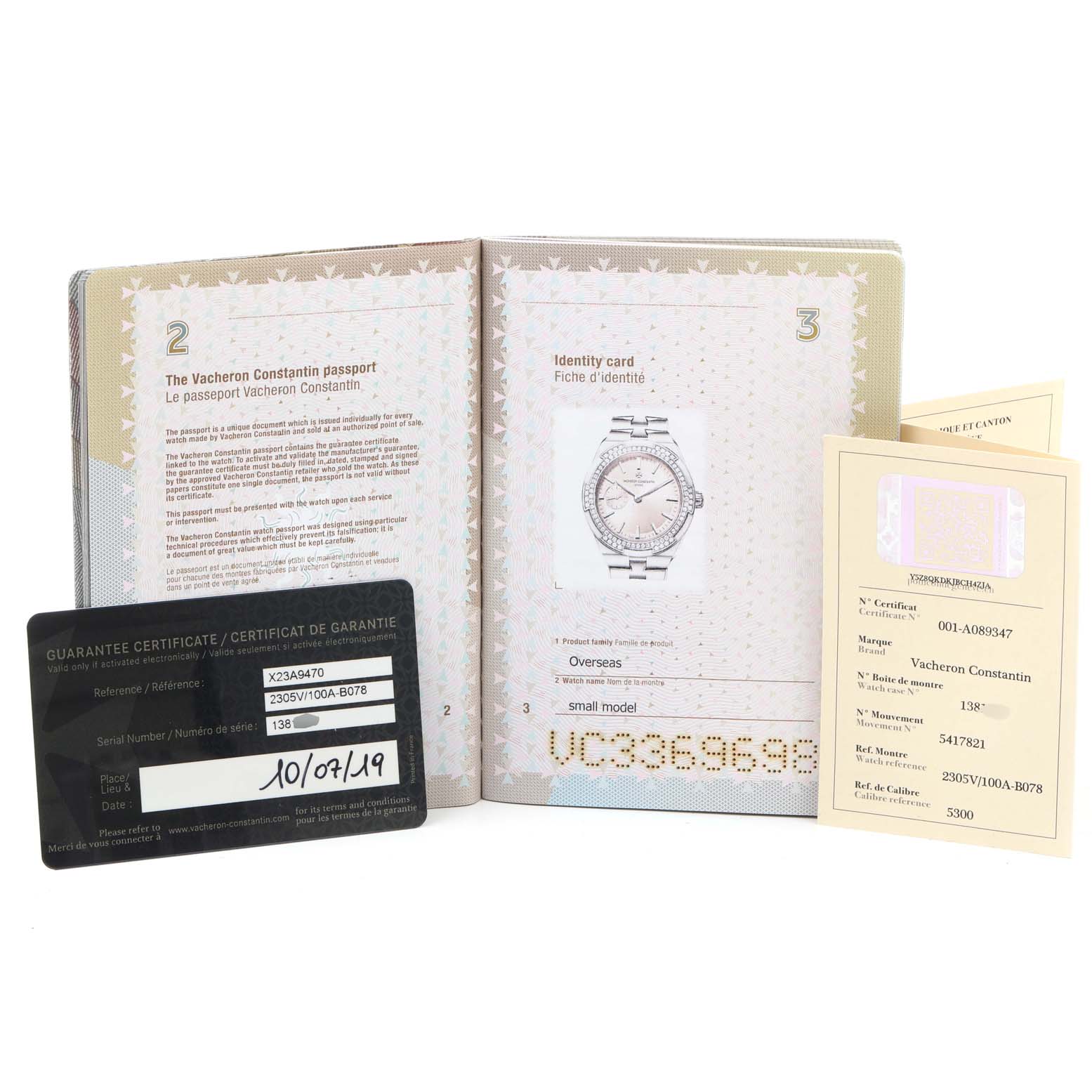 The image includes warranty cards and an identity card for the Vacheron Constantin Overseas 2305V/100A-B078 Women's Stainless Steel Pink Dial 2305V/100A-B078 Women's Stainless Steel Pink Dial model.